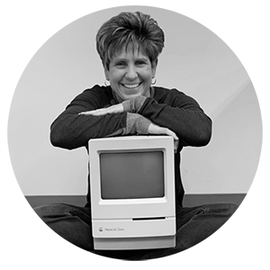 Jackie with an original Macintosh computer